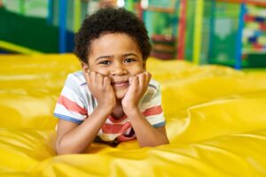 Cute Little Boy in Bouncy Castle